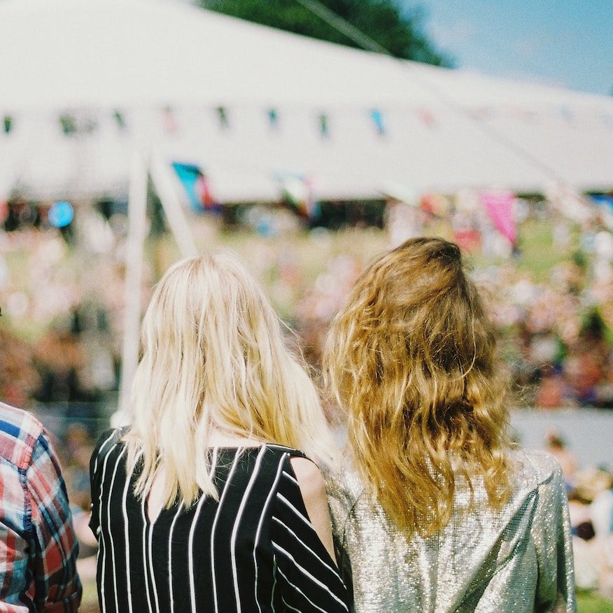 three person's standing front of field